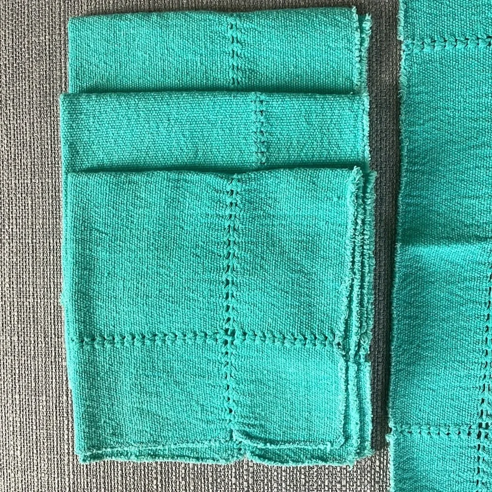 A set of four -3” square cotton napkins. Very soft.